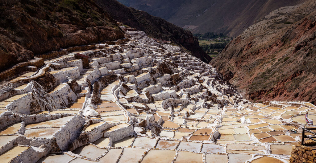 Close panoramic view of the Maras Salt Mines in Peru’s Sacred Valley, with white salt evaporation ponds cascading down the mountainside.